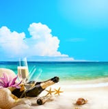 Art romantic sea beach. wine Glasses and Champagne Bottle on san