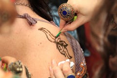Artist drawing henna tattoos. stock photo Artist drawing henna tattoos. stock photo