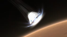 Space capsule descending to Mars.