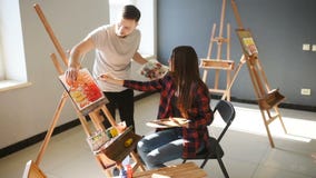 Artists paint pictures in the studio. Creative artists have designed a colorful picture painted on canvas with oil stock video footage Artists paint pictures in the studio. Creative artists have designed a colorful picture painted on canvas with oil stock video footage