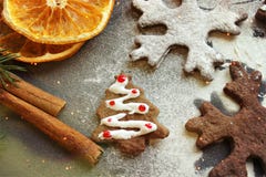 As cookies do Natal do cartão sob a forma dos flocos, decorados com laranja, as varas de canela e anis secados, o fundo são sprin fotografia de stock royalty free As cookies do Natal do cartão sob a forma dos flocos, decorados com laranja, as varas de canela e anis secados, o fundo são sprin fotografia de stock royalty free