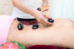 Asia beauty woman lying down on massage bed with traditional balinese hot stones along the spine at Thai spa and wellness center, royalty free stock photos Asia beauty woman lying down on massage bed with traditional balinese hot stones along the spine at Thai spa and wellness center, royalty free stock photos