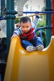 Asian Boy Playing The Sliding Board Stock Photo