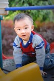 Asian Boy Playing The Sliding Board Royalty Free Stock Photo
