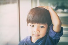 Asian boy is touching his head and hair royalty free stock images Asian boy is touching his head and hair royalty free stock images