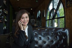 Asian business woman using mobile phone looking at camera royalty free stock photo Asian business woman using mobile phone looking at camera royalty free stock photo