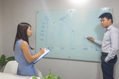 Asian businessman discussing with colleagues in the meeting room stock photo Asian businessman discussing with colleagues in the meeting room stock photo