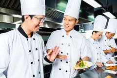 Asian Chef in restaurant kitchen cooking royalty free stock photography Asian Chef in restaurant kitchen cooking royalty free stock photography