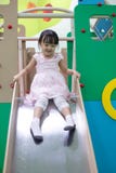 Asian Chinese little girl playing on the slide stock photo Asian Chinese little girl playing on the slide stock photo