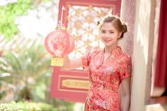 The Asian Chinese woman in Traditional Chinese hold red paper stock photo The Asian Chinese woman in Traditional Chinese hold red paper stock photo