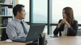 Asian corporate executives discussing business in office. Two asian corporate executives doing annual performance appraisal in office Asian corporate executives discussing business in office. Two asian corporate executives doing annual performance appraisal in office