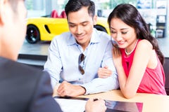 Asian Couple signing sales contract for car stock images Asian Couple signing sales contract for car stock images