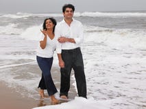 Asian Couple Walking In The Beach Stock Photo