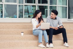 Asian couples students or colleagues sitting at the stairs and s stock photos Asian couples students or colleagues sitting at the stairs and s stock photos