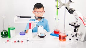 Asian Cute Child Learning Science In Laboratory On Gray Whit Background. Stock Photo