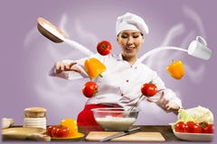 Asian female chef in the kitchen conjures stock images Asian female chef in the kitchen conjures stock images