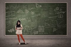 Asian female student standing on written board Royalty Free Stock Images Asian female student standing on written board Royalty Free Stock Images