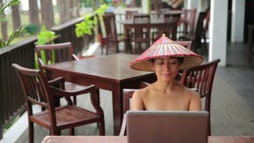 Asian freelance business woman at cafe with laptop and phone stock footage Asian freelance business woman at cafe with laptop and phone stock footage