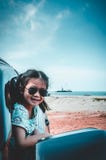 Asian girl smiling while sitting in the car. Travel on vacation Royalty Free Stock Photos Asian girl smiling while sitting in the car. Travel on vacation Royalty Free Stock Photos
