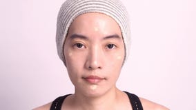 Asian girl making up by foundation liquid real no retouch stock image Asian girl making up by foundation liquid real no retouch stock image