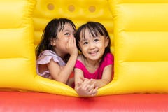 Asian Little Chinese sisters playing at inflatable castle stock photo Asian Little Chinese sisters playing at inflatable castle stock photo