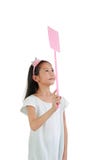 Asian little girl child holding pink flyswatter for attacking fly isolated on white background