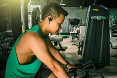 Asian man Bodybuilder with bicycle machine weights power handsome royalty free stock image Asian man Bodybuilder with bicycle machine weights power handsome royalty free stock image