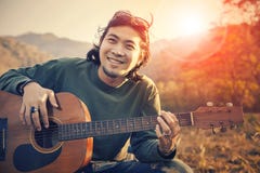 Asian Man Toothy Smiling Face With Happiness Playing Guitar And Royalty Free Stock Image