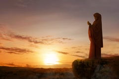 Asian muslim woman in veil raised hands and praying on the edge of the cliff royalty free stock photo Asian muslim woman in veil raised hands and praying on the edge of the cliff royalty free stock photo