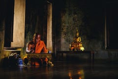 Asian Old monk thinking for writing something at Ayutthaya sanctuary temple in Thailand, about religion. stock photos Asian Old monk thinking for writing something at Ayutthaya sanctuary temple in Thailand, about religion. stock photos