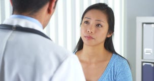 Asian patient describing wrist pain to doctor stock images Asian patient describing wrist pain to doctor stock images