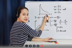 Asian school woman teacher working from home teach online math to student studying from home. Teacher writeing on whiteboard and