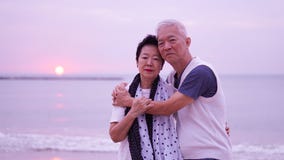 Asian senior couple dating at sunrise sea Royalty Free Stock Photos Asian senior couple dating at sunrise sea Royalty Free Stock Photos