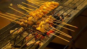 Asian Street Food. People Cooking, Selling And Buying Exotic Asian Food Stock Photo