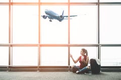 Asian traveler woman using smart phone and drinking coffee in airport for travel in holiday summer. stock image Asian traveler woman using smart phone and drinking coffee in airport for travel in holiday summer. stock image