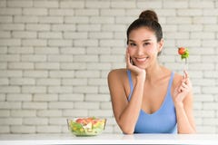 Asian woman in joyful postures with salad bowl on the side royalty free stock photo Asian woman in joyful postures with salad bowl on the side royalty free stock photo