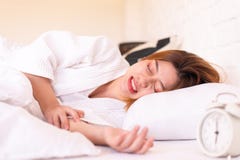 Asian Woman Sleeping On The Bed And Grinding Teeth,Female Bruxism Royalty Free Stock Image
