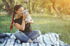 Asian Woman Took On Picnic Little Gray Bunny Royalty Free Stock Images