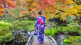 Asian woman wearing japanese traditional kimono in autumn park. Kyoto in Japan stock photos Asian woman wearing japanese traditional kimono in autumn park. Kyoto in Japan stock photos