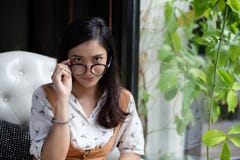 Asian women are holding glasses and smiling at a coffee shop on royalty free stock photo Asian women are holding glasses and smiling at a coffee shop on royalty free stock photo