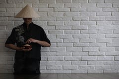 Asian young novice on a white brick wall royalty free stock photos Asian young novice on a white brick wall royalty free stock photos