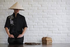 Asian young novice on a white brick wall stock photography Asian young novice on a white brick wall stock photography