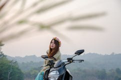 Asiatinreitmotorrad auf dem tropischen Gebiet stockfoto Asiatinreitmotorrad auf dem tropischen Gebiet stockfoto