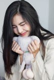 Asiatisches Mädchen umarmen ihre Puppe stockfotografie Asiatisches Mädchen umarmen ihre Puppe stockfotografie