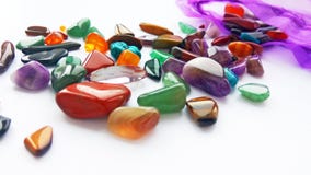 Bright coloured semi precious gemstones and gems in bag on white background royalty free stock photos Bright coloured semi precious gemstones and gems in bag on white background royalty free stock photos