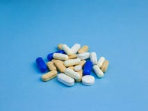 Assorted size and shape different pills on a blue background royalty free stock images Assorted size and shape different pills on a blue background royalty free stock images
