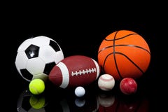 Assorted sports balls on a black background stock image Assorted sports balls on a black background stock image