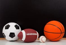 Assorted sports balls with a chalk board stock image Assorted sports balls with a chalk board stock image