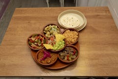 Assorted taco casseroles with wheat tortillas. Chicken tinga, cochinita pibil, chicken wire, guacamole with tortilla chips, beef