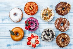 Assortment of donuts for any taste, on old wood background. Space for text. Top view royalty free stock photo Assortment of donuts for any taste, on old wood background. Space for text. Top view royalty free stock photo